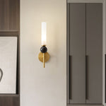 Elegant wall sconce with frosted glass shade, black marble accent, and a modern brushed gold finish.
