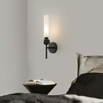 Elegant wall sconce with frosted glass shade, black marble accent, and a modern brushed gold finish.