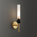 Elegant wall sconce with frosted glass shade, black marble accent, and a modern brushed gold finish.