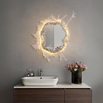Elegant wall mirror with splash-shaped frame and integrated LED lighting, perfect for modern décor.