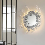 Elegant wall mirror with splash-shaped frame and integrated LED lighting, perfect for modern décor.