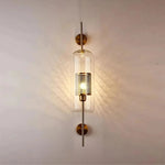 Elegant glass lantern wall sconce with a modern metal frame, perfect for ambient lighting in living rooms and bedrooms.