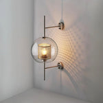 Elegant glass lantern wall sconce with a modern metal frame, perfect for ambient lighting in living rooms and bedrooms.