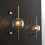 Elegant glass lantern wall sconce with a modern metal frame, perfect for ambient lighting in living rooms and bedrooms.