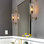 Elegant glass lantern wall sconce with a modern metal frame, perfect for ambient lighting in living rooms and bedrooms.