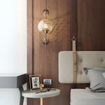 Elegant glass lantern wall sconce with a modern metal frame, perfect for ambient lighting in living rooms and bedrooms.