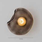 Artistic glass wall sconce with a wave-inspired design, ideal for ambient lighting in modern living rooms, bedrooms, and hallways