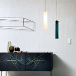 Elegant linear glass pendant light with sleek modern design, ideal for dining rooms, kitchens, and contemporary interiors.